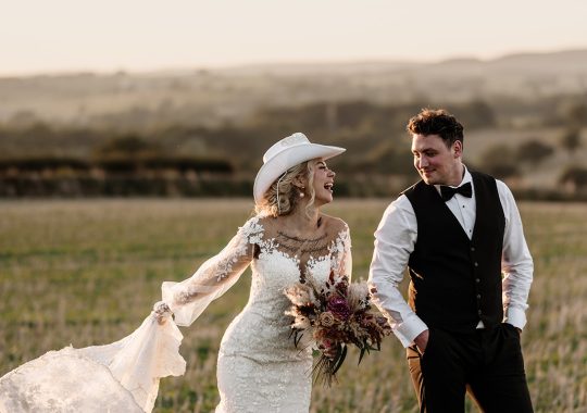 • “Bride and groom standing hand in hand outside Runa Farm’s rustic stone barn – a perfect Durham wedding venue.” • “Candid wedding moment at Runa Farm – newlyweds laughing together under twinkling lights.” • “Elegant boho wedding dress at Runa Farm – bride posing against the venue’s countryside backdrop.” • “Runa Farm wedding setup – long wooden tables, rustic décor, and soft candlelight for a romantic reception.” • “Sunset wedding portraits at Runa Farm – golden hour glow over the rolling Durham countryside.” • “Stylish groom at Runa Farm – a modern take on rustic wedding fashion.” • “The moment they said ‘I do’ – bride and groom exchanging vows in Runa Farm’s barn ceremony space.” • “Runa Farm wedding celebrations – guests raising a toast in a beautifully styled barn reception.” • “Newlyweds sharing their first dance at Runa Farm – a magical moment under fairy lights.” • “Fun wedding party portraits at Runa Farm – bridesmaids and groomsmen celebrating in the countryside.” • “Beautiful wedding bouquet at Runa Farm – dried florals, soft pastels, and rustic charm.” • “Relaxed wedding morning at Runa Farm – bride enjoying a quiet moment before the ceremony.” • “Outdoor wedding drinks reception at Runa Farm – couples and guests enjoying the sunshine and countryside views.” • “Romantic countryside wedding at Runa Farm – couple walking through lush fields at sunset.” • “Runa Farm wedding cake – elegant design with dried flowers and a rustic-luxe finish.” • “Bridal party getting ready at Runa Farm – laughter, champagne, and the perfect pre-wedding moments.” • “Emotional groom watching his bride walk down the aisle at Runa Farm’s intimate barn setting.” • “Boho-inspired wedding styling at Runa Farm – warm tones, pampas grass, and rustic wooden details.” • “Confetti moment at Runa Farm – bride and groom celebrating with family and friends in a joyful shower of petals.” • “Romantic wedding reception at Runa Farm – candlelit tables, rustic beams, and a warm, cozy atmosphere.” • “Bride and groom sharing a private moment outside Runa Farm’s stunning stone architecture.” • “Wedding guests enjoying a relaxed al fresco drinks reception at Runa Farm’s outdoor courtyard.” • “Rustic barn wedding inspiration at Runa Farm – dreamy styling with fairy lights and natural textures.” • “Newlyweds embracing outside Runa Farm’s picturesque countryside backdrop – the perfect Durham wedding setting.” • “Groom waiting at the altar at Runa Farm – the perfect rustic wedding venue for an intimate ceremony.” • “Bridal portraits at Runa Farm – timeless elegance meets countryside charm.” • “Golden hour wedding photography at Runa Farm – romantic sunset portraits of the newlyweds.” • “Sparkler exit at Runa Farm – magical wedding send-off under a starry North East sky.” • “Bride and groom sharing a relaxed moment by Runa Farm’s rustic wooden gates.” • “Romantic first look at Runa Farm – groom’s emotional reaction to seeing his bride.” • “Natural wedding photography at Runa Farm – capturing authentic moments of love and joy.” • “Bridal details at Runa Farm – lace wedding gown, delicate florals, and rustic-chic styling.” • “Outdoor wedding portraits at Runa Farm – capturing the couple in a breathtaking countryside setting.” • “Guests celebrating at Runa Farm wedding reception – joyful candid moments on the dance floor.” • “Modern rustic wedding décor at Runa Farm – beautifully styled tables with earthy tones and fresh flowers.” • “Newlyweds enjoying a quiet moment at Runa Farm’s scenic outdoor spaces.” • “Groom buttoning up his suit before the ceremony at Runa Farm – stylish and relaxed wedding morning.” • “Wedding party group shots at Runa Farm – fun, natural, and full of personality.” • “Intimate wedding dinner setup at Runa Farm – romantic lighting and beautifully arranged tables.”
