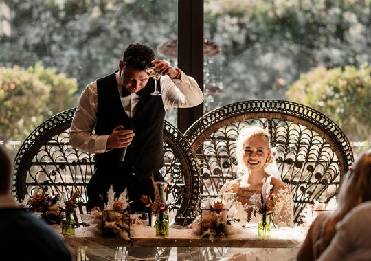 • “Bride and groom standing hand in hand outside Runa Farm’s rustic stone barn – a perfect Durham wedding venue.” • “Candid wedding moment at Runa Farm – newlyweds laughing together under twinkling lights.” • “Elegant boho wedding dress at Runa Farm – bride posing against the venue’s countryside backdrop.” • “Runa Farm wedding setup – long wooden tables, rustic décor, and soft candlelight for a romantic reception.” • “Sunset wedding portraits at Runa Farm – golden hour glow over the rolling Durham countryside.” • “Stylish groom at Runa Farm – a modern take on rustic wedding fashion.” • “The moment they said ‘I do’ – bride and groom exchanging vows in Runa Farm’s barn ceremony space.” • “Runa Farm wedding celebrations – guests raising a toast in a beautifully styled barn reception.” • “Newlyweds sharing their first dance at Runa Farm – a magical moment under fairy lights.” • “Fun wedding party portraits at Runa Farm – bridesmaids and groomsmen celebrating in the countryside.” • “Beautiful wedding bouquet at Runa Farm – dried florals, soft pastels, and rustic charm.” • “Relaxed wedding morning at Runa Farm – bride enjoying a quiet moment before the ceremony.” • “Outdoor wedding drinks reception at Runa Farm – couples and guests enjoying the sunshine and countryside views.” • “Romantic countryside wedding at Runa Farm – couple walking through lush fields at sunset.” • “Runa Farm wedding cake – elegant design with dried flowers and a rustic-luxe finish.” • “Bridal party getting ready at Runa Farm – laughter, champagne, and the perfect pre-wedding moments.” • “Emotional groom watching his bride walk down the aisle at