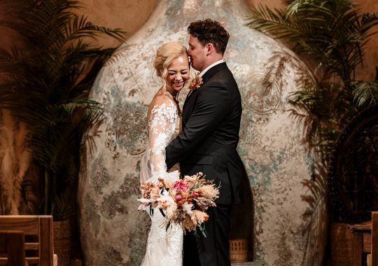 • “Bride and groom standing hand in hand outside Runa Farm’s rustic stone barn – a perfect Durham wedding venue.” • “Candid wedding moment at Runa Farm – newlyweds laughing together under twinkling lights.” • “Elegant boho wedding dress at Runa Farm – bride posing against the venue’s countryside backdrop.” • “Runa Farm wedding setup – long wooden tables, rustic décor, and soft candlelight for a romantic reception.” • “Sunset wedding portraits at Runa Farm – golden hour glow over the rolling Durham countryside.” • “Stylish groom at Runa Farm – a modern take on rustic wedding fashion.” • “The moment they said ‘I do’ – bride and groom exchanging vows in Runa Farm’s barn ceremony space.” • “Runa Farm wedding celebrations – guests raising a toast in a beautifully styled barn reception.” • “Newlyweds sharing their first dance at Runa Farm – a magical moment under fairy lights.” • “Fun wedding party portraits at Runa Farm – bridesmaids and groomsmen celebrating in the countryside.” • “Beautiful wedding bouquet at Runa Farm – dried florals, soft pastels, and rustic charm.” • “Relaxed wedding morning at Runa Farm – bride enjoying a quiet moment before the ceremony.” • “Outdoor wedding drinks reception at Runa Farm – couples and guests enjoying the sunshine and countryside views.” • “Romantic countryside wedding at Runa Farm – couple walking through lush fields at sunset.” • “Runa Farm wedding cake – elegant design with dried flowers and a rustic-luxe finish.” • “Bridal party getting ready at Runa Farm – laughter, champagne, and the perfect pre-wedding moments.” • “Emotional groom watching his bride walk down the aisle at