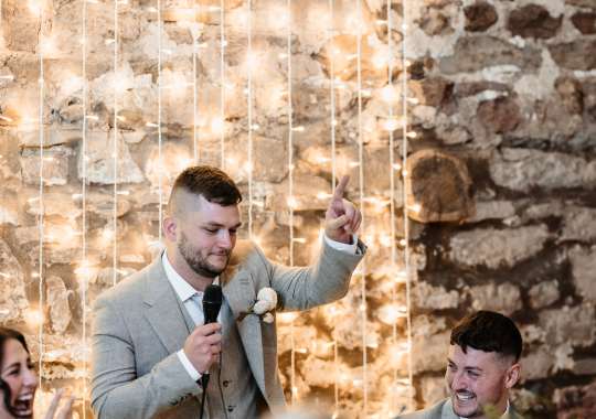 Romantic wedding at Eden Barn, Cumbria – rustic stone barn with fairy lights and countryside views. Bride and groom at Eden Barn, a charming wedding venue in Cumbria with exposed stone walls and wooden beams. Rustic wedding reception at Eden Barn – elegant tablescapes, candlelight, and floral decor in a historic barn setting. Outdoor wedding ceremony at Eden Barn, Cumbria – scenic countryside backdrop with a beautifully styled aisle. Bride and groom sharing their first dance under fairy lights in the atmospheric Eden Barn, Cumbria. Candid wedding photography at Eden Barn – newlyweds enjoying a golden hour moment in the Cumbrian countryside. Intimate wedding dinner at Eden Barn, Cumbria – rustic wooden tables, greenery, and soft lighting. Eden Barn wedding venue – a romantic, family-run barn in the heart of Cumbria’s rolling countryside. Bridal portrait at Eden Barn, Cumbria – stunning wedding dress captured in soft natural light. Groom’s first look reaction at Eden Barn – emotional moment in a rustic barn wedding setting. Evening wedding reception at Eden Barn – cozy, candlelit barn with fairy lights and dancing. Wedding cake display at Eden Barn, Cumbria – beautifully decorated rustic cake with floral accents. Bridal party celebrations at Eden Barn – bridesmaids and groomsmen enjoying the stunning countryside venue. Sunset wedding photography at Eden Barn – breathtaking golden hour shots of the newlyweds. Confetti moment at Eden Barn, Cumbria – joyful wedding guests celebrating outside the historic stone barn. Rustic wedding details at Eden Barn – boho-inspired table settings, wildflowers, and vintage decor. Emotional wedding vows at Eden Barn – heartfelt ceremony in a charming countryside barn setting. Bride and groom walking hand in hand at Eden Barn – natural and relaxed wedding photography. Live wedding band at Eden Barn – guests dancing under the twinkling fairy lights in a rustic barn venue. Luxury barn wedding at Eden Barn, Cumbria – elegant styling meets countryside charm for the perfect day.