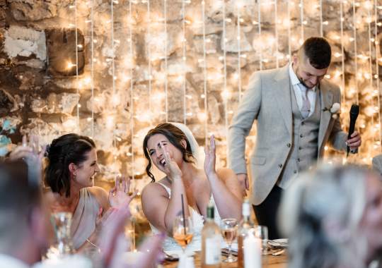 Romantic wedding at Eden Barn, Cumbria – rustic stone barn with fairy lights and countryside views. Bride and groom at Eden Barn, a charming wedding venue in Cumbria with exposed stone walls and wooden beams. Rustic wedding reception at Eden Barn – elegant tablescapes, candlelight, and floral decor in a historic barn setting. Outdoor wedding ceremony at Eden Barn, Cumbria – scenic countryside backdrop with a beautifully styled aisle. Bride and groom sharing their first dance under fairy lights in the atmospheric Eden Barn, Cumbria. Candid wedding photography at Eden Barn – newlyweds enjoying a golden hour moment in the Cumbrian countryside. Intimate wedding dinner at Eden Barn, Cumbria – rustic wooden tables, greenery, and soft lighting. Eden Barn wedding venue – a romantic, family-run barn in the heart of Cumbria’s rolling countryside. Bridal portrait at Eden Barn, Cumbria – stunning wedding dress captured in soft natural light. Groom’s first look reaction at Eden Barn – emotional moment in a rustic barn wedding setting. Evening wedding reception at Eden Barn – cozy, candlelit barn with fairy lights and dancing. Wedding cake display at Eden Barn, Cumbria – beautifully decorated rustic cake with floral accents. Bridal party celebrations at Eden Barn – bridesmaids and groomsmen enjoying the stunning countryside venue. Sunset wedding photography at Eden Barn – breathtaking golden hour shots of the newlyweds. Confetti moment at Eden Barn, Cumbria – joyful wedding guests celebrating outside the historic stone barn. Rustic wedding details at Eden Barn – boho-inspired table settings, wildflowers, and vintage decor. Emotional wedding vows at Eden Barn – heartfelt ceremony in a charming countryside barn setting. Bride and groom walking hand in hand at Eden Barn – natural and relaxed wedding photography. Live wedding band at Eden Barn – guests dancing under the twinkling fairy lights in a rustic barn venue. Luxury barn wedding at Eden Barn, Cumbria – elegant styling meets countryside charm for the perfect day.