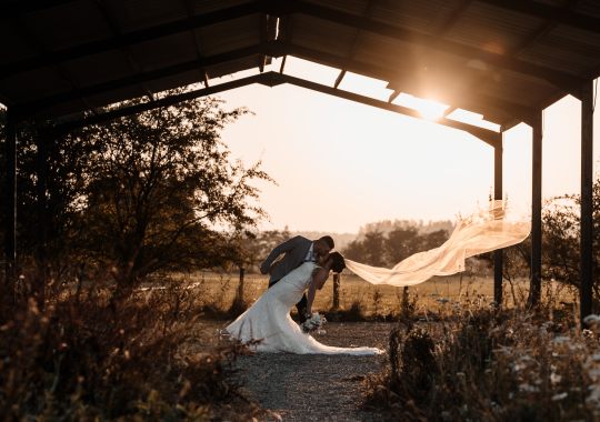 Romantic wedding at Eden Barn, Cumbria – rustic stone barn with fairy lights and countryside views. Bride and groom at Eden Barn, a charming wedding venue in Cumbria with exposed stone walls and wooden beams. Rustic wedding reception at Eden Barn – elegant tablescapes, candlelight, and floral decor in a historic barn setting. Outdoor wedding ceremony at Eden Barn, Cumbria – scenic countryside backdrop with a beautifully styled aisle. Bride and groom sharing their first dance under fairy lights in the atmospheric Eden Barn, Cumbria. Candid wedding photography at Eden Barn – newlyweds enjoying a golden hour moment in the Cumbrian countryside. Intimate wedding dinner at Eden Barn, Cumbria – rustic wooden tables, greenery, and soft lighting. Eden Barn wedding venue – a romantic, family-run barn in the heart of Cumbria’s rolling countryside. Bridal portrait at Eden Barn, Cumbria – stunning wedding dress captured in soft natural light. Groom’s first look reaction at Eden Barn – emotional moment in a rustic barn wedding setting. Evening wedding reception at Eden Barn – cozy, candlelit barn with fairy lights and dancing. Wedding cake display at Eden Barn, Cumbria – beautifully decorated rustic cake with floral accents. Bridal party celebrations at Eden Barn – bridesmaids and groomsmen enjoying the stunning countryside venue. Sunset wedding photography at Eden Barn – breathtaking golden hour shots of the newlyweds. Confetti moment at Eden Barn, Cumbria – joyful wedding guests celebrating outside the historic stone barn. Rustic wedding details at Eden Barn – boho-inspired table settings, wildflowers, and vintage decor. Emotional wedding vows at Eden Barn – heartfelt ceremony in a charming countryside barn setting. Bride and groom walking hand in hand at Eden Barn – natural and relaxed wedding photography. Live wedding band at Eden Barn – guests dancing under the twinkling fairy lights in a rustic barn venue. Luxury barn wedding at Eden Barn, Cumbria – elegant styling meets countryside charm for the perfect day.