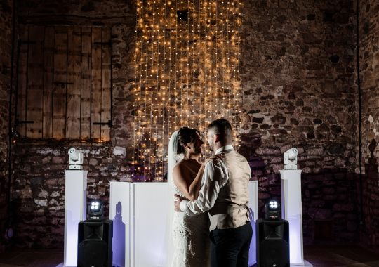 Romantic wedding at Eden Barn, Cumbria – rustic stone barn with fairy lights and countryside views. Bride and groom at Eden Barn, a charming wedding venue in Cumbria with exposed stone walls and wooden beams. Rustic wedding reception at Eden Barn – elegant tablescapes, candlelight, and floral decor in a historic barn setting. Outdoor wedding ceremony at Eden Barn, Cumbria – scenic countryside backdrop with a beautifully styled aisle. Bride and groom sharing their first dance under fairy lights in the atmospheric Eden Barn, Cumbria. Candid wedding photography at Eden Barn – newlyweds enjoying a golden hour moment in the Cumbrian countryside. Intimate wedding dinner at Eden Barn, Cumbria – rustic wooden tables, greenery, and soft lighting. Eden Barn wedding venue – a romantic, family-run barn in the heart of Cumbria’s rolling countryside. Bridal portrait at Eden Barn, Cumbria – stunning wedding dress captured in soft natural light. Groom’s first look reaction at Eden Barn – emotional moment in a rustic barn wedding setting. Evening wedding reception at Eden Barn – cozy, candlelit barn with fairy lights and dancing. Wedding cake display at Eden Barn, Cumbria – beautifully decorated rustic cake with floral accents. Bridal party celebrations at Eden Barn – bridesmaids and groomsmen enjoying the stunning countryside venue. Sunset wedding photography at Eden Barn – breathtaking golden hour shots of the newlyweds. Confetti moment at Eden Barn, Cumbria – joyful wedding guests celebrating outside the historic stone barn. Rustic wedding details at Eden Barn – boho-inspired table settings, wildflowers, and vintage decor. Emotional wedding vows at Eden Barn – heartfelt ceremony in a charming countryside barn setting. Bride and groom walking hand in hand at Eden Barn – natural and relaxed wedding photography. Live wedding band at Eden Barn – guests dancing under the twinkling fairy lights in a rustic barn venue. Luxury barn wedding at Eden Barn, Cumbria – elegant styling meets countryside charm for the perfect day.