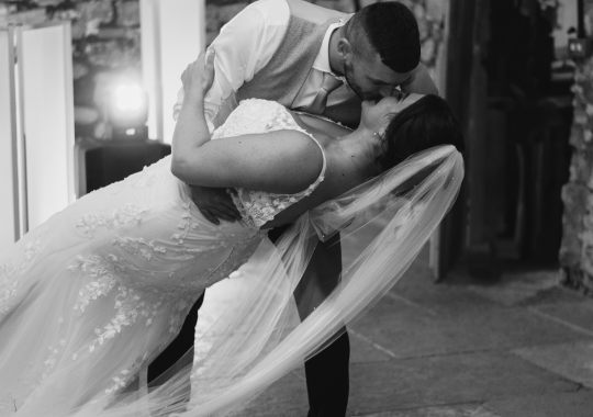 Romantic wedding at Eden Barn, Cumbria – rustic stone barn with fairy lights and countryside views. Bride and groom at Eden Barn, a charming wedding venue in Cumbria with exposed stone walls and wooden beams. Rustic wedding reception at Eden Barn – elegant tablescapes, candlelight, and floral decor in a historic barn setting. Outdoor wedding ceremony at Eden Barn, Cumbria – scenic countryside backdrop with a beautifully styled aisle. Bride and groom sharing their first dance under fairy lights in the atmospheric Eden Barn, Cumbria. Candid wedding photography at Eden Barn – newlyweds enjoying a golden hour moment in the Cumbrian countryside. Intimate wedding dinner at Eden Barn, Cumbria – rustic wooden tables, greenery, and soft lighting. Eden Barn wedding venue – a romantic, family-run barn in the heart of Cumbria’s rolling countryside. Bridal portrait at Eden Barn, Cumbria – stunning wedding dress captured in soft natural light. Groom’s first look reaction at Eden Barn – emotional moment in a rustic barn wedding setting. Evening wedding reception at Eden Barn – cozy, candlelit barn with fairy lights and dancing. Wedding cake display at Eden Barn, Cumbria – beautifully decorated rustic cake with floral accents. Bridal party celebrations at Eden Barn – bridesmaids and groomsmen enjoying the stunning countryside venue. Sunset wedding photography at Eden Barn – breathtaking golden hour shots of the newlyweds. Confetti moment at Eden Barn, Cumbria – joyful wedding guests celebrating outside the historic stone barn. Rustic wedding details at Eden Barn – boho-inspired table settings, wildflowers, and vintage decor. Emotional wedding vows at Eden Barn – heartfelt ceremony in a charming countryside barn setting. Bride and groom walking hand in hand at Eden Barn – natural and relaxed wedding photography. Live wedding band at Eden Barn – guests dancing under the twinkling fairy lights in a rustic barn venue. Luxury barn wedding at Eden Barn, Cumbria – elegant styling meets countryside charm for the perfect day.