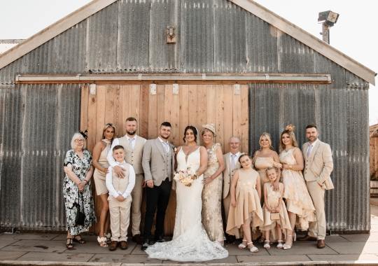Romantic wedding at Eden Barn, Cumbria – rustic stone barn with fairy lights and countryside views. Bride and groom at Eden Barn, a charming wedding venue in Cumbria with exposed stone walls and wooden beams. Rustic wedding reception at Eden Barn – elegant tablescapes, candlelight, and floral decor in a historic barn setting. Outdoor wedding ceremony at Eden Barn, Cumbria – scenic countryside backdrop with a beautifully styled aisle. Bride and groom sharing their first dance under fairy lights in the atmospheric Eden Barn, Cumbria. Candid wedding photography at Eden Barn – newlyweds enjoying a golden hour moment in the Cumbrian countryside. Intimate wedding dinner at Eden Barn, Cumbria – rustic wooden tables, greenery, and soft lighting. Eden Barn wedding venue – a romantic, family-run barn in the heart of Cumbria’s rolling countryside. Bridal portrait at Eden Barn, Cumbria – stunning wedding dress captured in soft natural light. Groom’s first look reaction at Eden Barn – emotional moment in a rustic barn wedding setting. Evening wedding reception at Eden Barn – cozy, candlelit barn with fairy lights and dancing. Wedding cake display at Eden Barn, Cumbria – beautifully decorated rustic cake with floral accents. Bridal party celebrations at Eden Barn – bridesmaids and groomsmen enjoying the stunning countryside venue. Sunset wedding photography at Eden Barn – breathtaking golden hour shots of the newlyweds. Confetti moment at Eden Barn, Cumbria – joyful wedding guests celebrating outside the historic stone barn. Rustic wedding details at Eden Barn – boho-inspired table settings, wildflowers, and vintage decor. Emotional wedding vows at Eden Barn – heartfelt ceremony in a charming countryside barn setting. Bride and groom walking hand in hand at Eden Barn – natural and relaxed wedding photography. Live wedding band at Eden Barn – guests dancing under the twinkling fairy lights in a rustic barn venue. Luxury barn wedding at Eden Barn, Cumbria – elegant styling meets countryside charm for the perfect day.