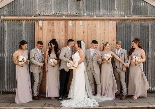 Romantic wedding at Eden Barn, Cumbria – rustic stone barn with fairy lights and countryside views. Bride and groom at Eden Barn, a charming wedding venue in Cumbria with exposed stone walls and wooden beams. Rustic wedding reception at Eden Barn – elegant tablescapes, candlelight, and floral decor in a historic barn setting. Outdoor wedding ceremony at Eden Barn, Cumbria – scenic countryside backdrop with a beautifully styled aisle. Bride and groom sharing their first dance under fairy lights in the atmospheric Eden Barn, Cumbria. Candid wedding photography at Eden Barn – newlyweds enjoying a golden hour moment in the Cumbrian countryside. Intimate wedding dinner at Eden Barn, Cumbria – rustic wooden tables, greenery, and soft lighting. Eden Barn wedding venue – a romantic, family-run barn in the heart of Cumbria’s rolling countryside. Bridal portrait at Eden Barn, Cumbria – stunning wedding dress captured in soft natural light. Groom’s first look reaction at Eden Barn – emotional moment in a rustic barn wedding setting. Evening wedding reception at Eden Barn – cozy, candlelit barn with fairy lights and dancing. Wedding cake display at Eden Barn, Cumbria – beautifully decorated rustic cake with floral accents. Bridal party celebrations at Eden Barn – bridesmaids and groomsmen enjoying the stunning countryside venue. Sunset wedding photography at Eden Barn – breathtaking golden hour shots of the newlyweds. Confetti moment at Eden Barn, Cumbria – joyful wedding guests celebrating outside the historic stone barn. Rustic wedding details at Eden Barn – boho-inspired table settings, wildflowers, and vintage decor. Emotional wedding vows at Eden Barn – heartfelt ceremony in a charming countryside barn setting. Bride and groom walking hand in hand at Eden Barn – natural and relaxed wedding photography. Live wedding band at Eden Barn – guests dancing under the twinkling fairy lights in a rustic barn venue. Luxury barn wedding at Eden Barn, Cumbria – elegant styling meets countryside charm for the perfect day.