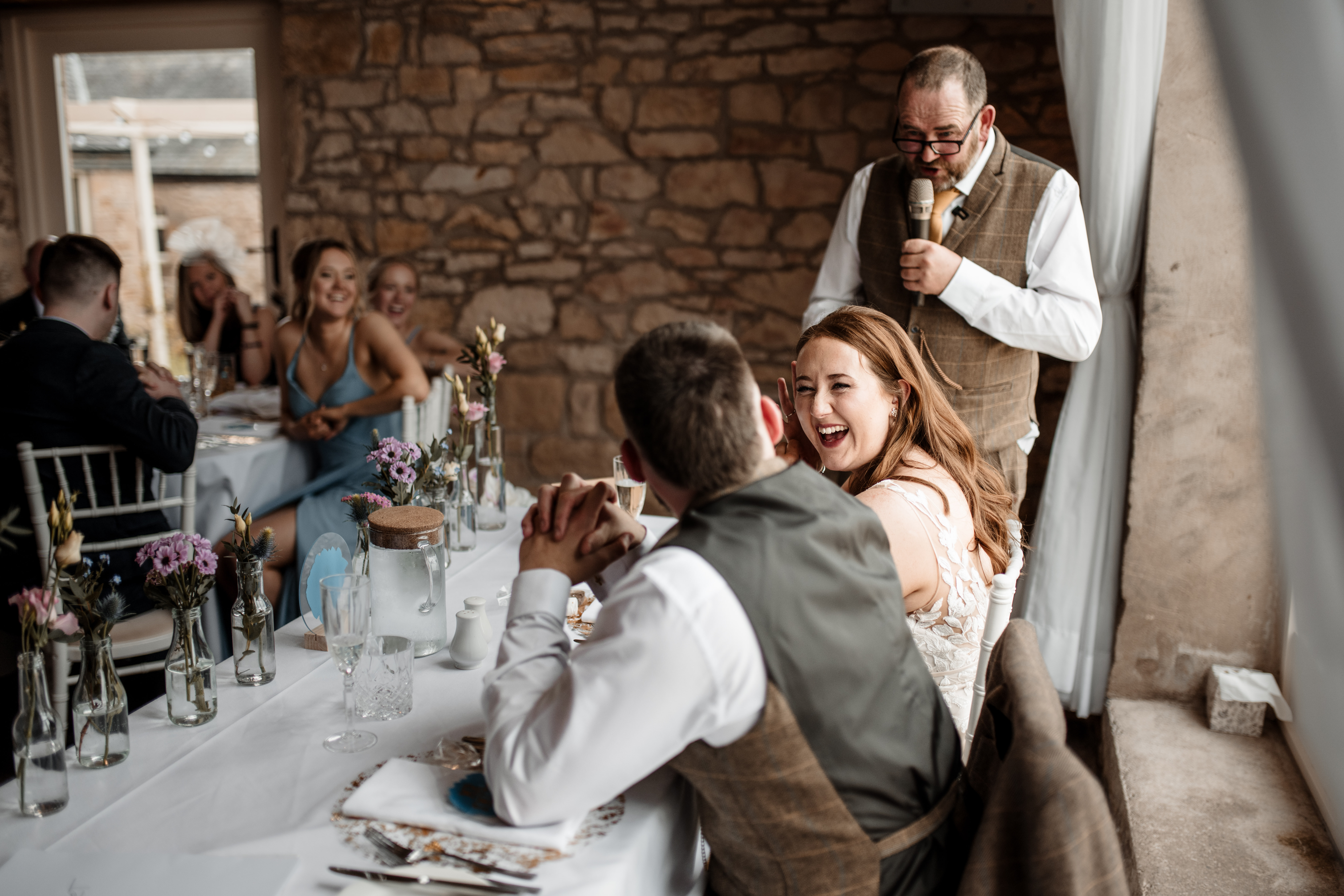 Bride and groom at Northside Farm wedding, Northumberland countryside backdrop Rustic barn wedding ceremony at Northside Farm with fairy lights and wooden beams Golden hour wedding portraits at Northside Farm, Northumberland Couple’s first dance inside Northside Farm barn, surrounded by twinkling lights Bride getting ready in Northside Farm shepherd’s hut on wedding morning Natural countryside wedding photography at Northside Farm, UK Candid wedding guest moments at Northside Farm barn reception Outdoor wedding portraits at Northside Farm with rolling hills and open fields Groom waiting at the altar inside Northside Farm’s rustic barn wedding venue Relaxed, fun wedding photography at Northside Farm in Northumberland