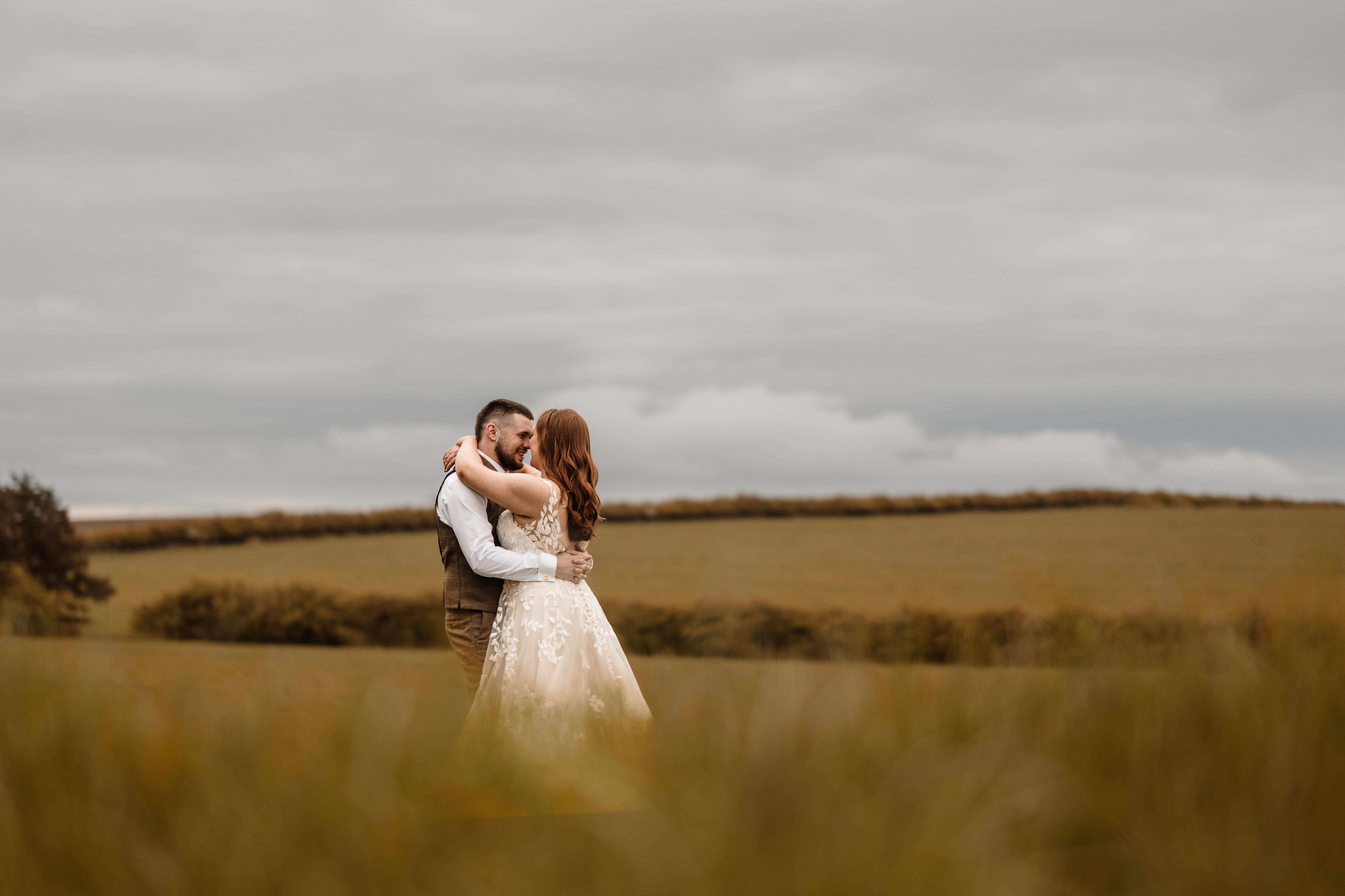 Bride and groom at Northside Farm wedding, Northumberland countryside backdrop Rustic barn wedding ceremony at Northside Farm with fairy lights and wooden beams Golden hour wedding portraits at Northside Farm, Northumberland Couple’s first dance inside Northside Farm barn, surrounded by twinkling lights Bride getting ready in Northside Farm shepherd’s hut on wedding morning Natural countryside wedding photography at Northside Farm, UK Candid wedding guest moments at Northside Farm barn reception Outdoor wedding portraits at Northside Farm with rolling hills and open fields Groom waiting at the altar inside Northside Farm’s rustic barn wedding venue Relaxed, fun wedding photography at Northside Farm in Northumberland