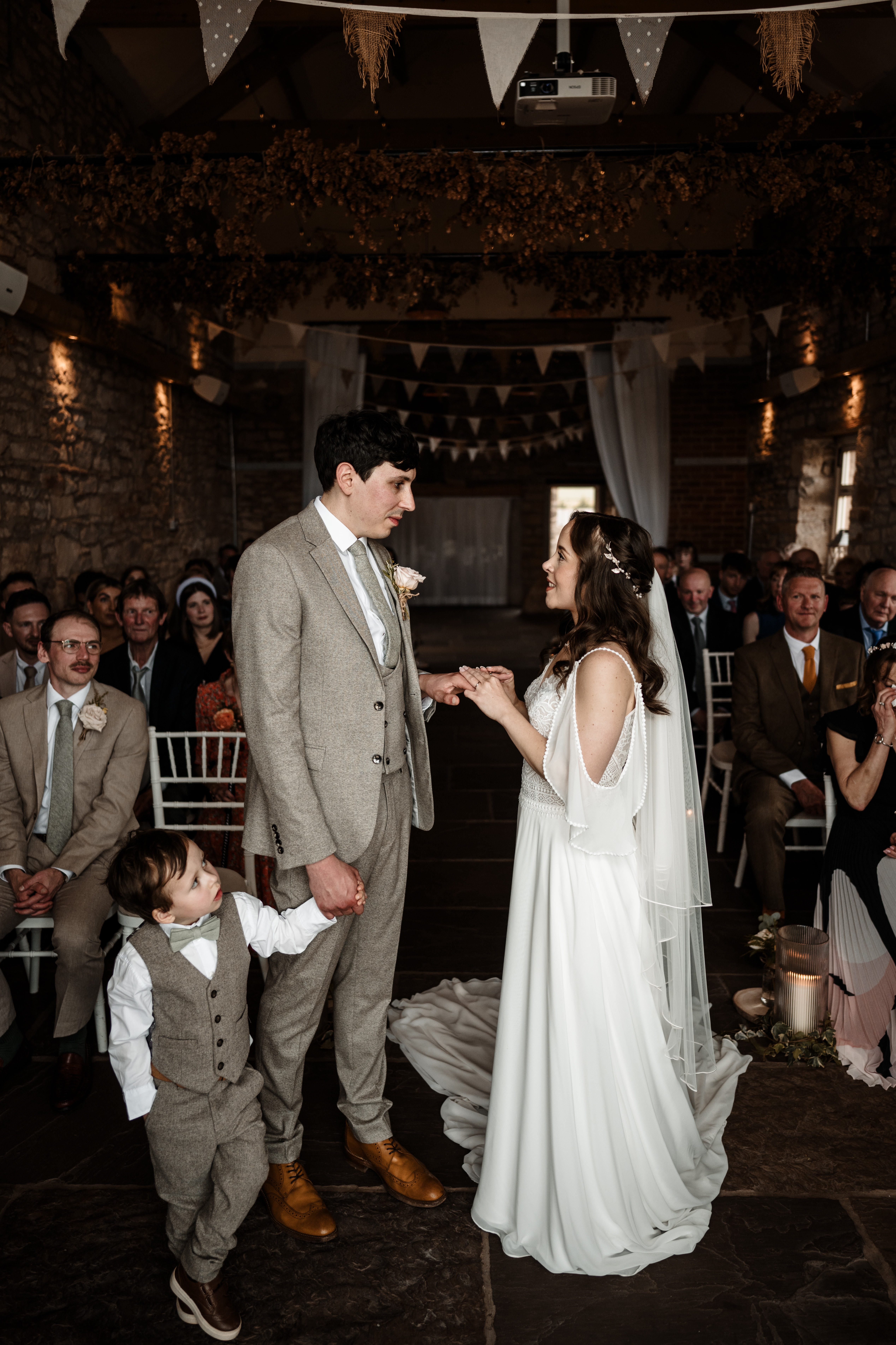 Bride and groom walking hand in hand at Northside Farm wedding venue Romantic countryside wedding photography at Northside Farm, Northumberland Rustic barn wedding reception with fairy lights and wooden beams at Northside Farm Bride and groom sharing a quiet moment outside Northside Farm’s stone barn Golden hour wedding couple portraits at Northside Farm with rolling hills in the background Natural and candid wedding photography at Northside Farm, UK Guests celebrating at a Northside Farm wedding reception inside the barn Bride getting ready inside a shepherd’s hut at Northside Farm wedding venue Couple’s first kiss as newlyweds at Northside Farm’s rustic barn ceremony Emotional first look between bride and groom at Northside Farm, Northumberland