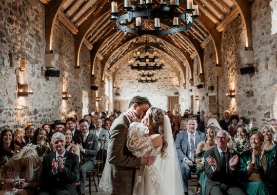 “Romantic wedding ceremony inside Healey Barn, Northumberland – candlelit aisle and rustic stone walls.” “Bride and groom share a kiss outside Healey Barn – a stunning North East barn wedding venue.” “Sunset wedding portraits at Healey Barn – golden hour glow over the Northumberland countryside.” “Rustic wedding reception at Healey Barn – twinkling fairy lights, wooden beams, and a cozy atmosphere.” “Bride walking down the aisle at Healey Barn – intimate ceremony with candlelight and exposed stone walls.” “Outdoor wedding portraits at Healey Barn – newlyweds surrounded by rolling countryside views.” “Groom’s emotional first look at his bride at Healey Barn – a perfect wedding moment captured.” “Elegant barn wedding setup at Healey Barn – rustic wooden tables, floral centerpieces, and romantic lighting.” “Bride and groom celebrating outside Healey Barn – natural and relaxed wedding photography in Northumberland.” “Lively wedding reception at Healey Barn – guests dancing under the rustic beams and fairy lights.” “Romantic first dance at Healey Barn – newlyweds twirling in the candlelit barn reception.” “Bridal prep at Healey Barn – bride getting ready in a stylish, rustic setting.” “Confetti moment at Healey Barn – newlyweds celebrating with guests outside the venue.” “Golden hour wedding photography at Healey Barn – dreamy countryside backdrop with warm sunlight.” “Boho-inspired wedding at Healey Barn – dried florals, rustic décor, and warm candlelight.” “Groom and groomsmen laughing outside Healey Barn – relaxed and fun wedding moments.” “Romantic couple portraits in front of Healey Barn’s stone walls – perfect for a rustic wedding setting.”